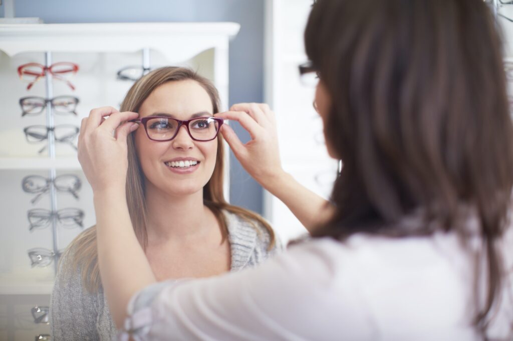 Woman at the optician trying on glasses